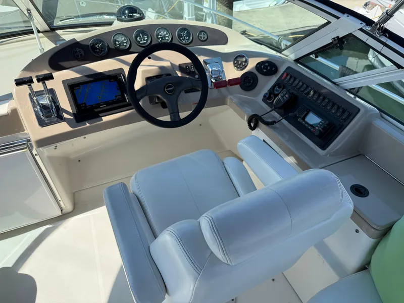 Slide: The Image of 2006 Carver 36 Mariner helm with steering wheel, gauges, and navigation equipment. - 12