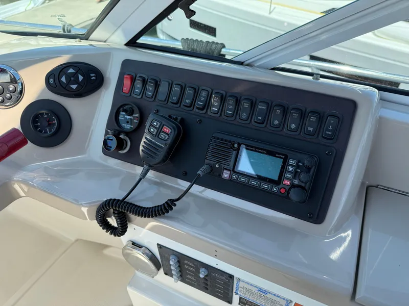 Slide: The Image of Control panel of a 2006 Carver 36 Mariner boat with radio and switches. - 17