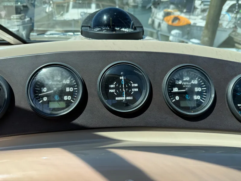 Slide: The Image of Dashboard of a 2006 Carver 36 Mariner boat with gauges and compass. - 19