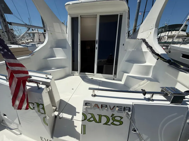 Slide: The Image of 2006 Carver 36 Mariner yacht deck with American flag and sliding door. - 2