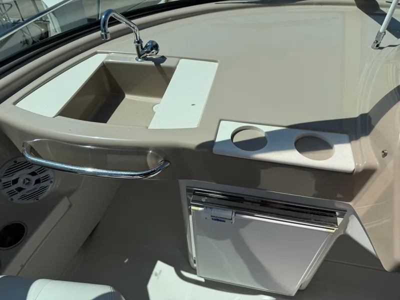 Slide: The Image of 2006 Carver 36 Mariner boat interior with sink, cup holders, and mini fridge. - 21