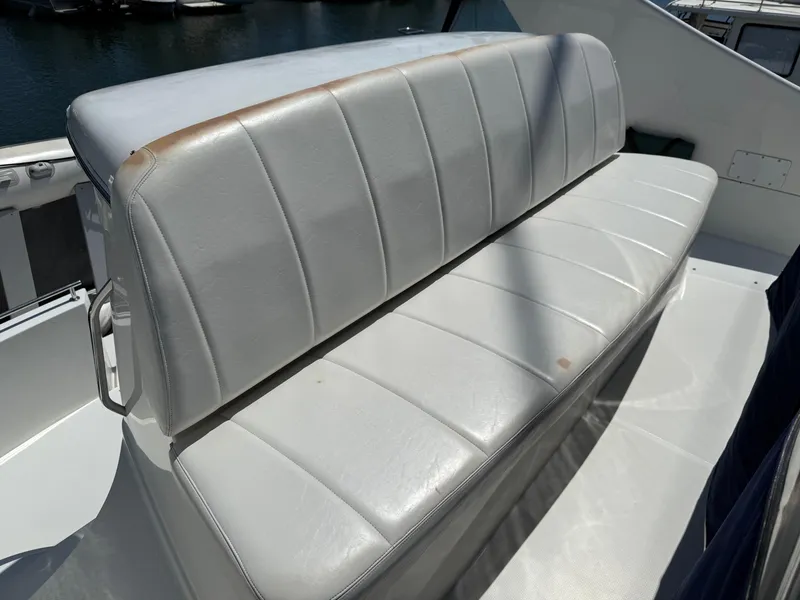Slide: The Image of White leather seating on 2006 Carver 36 Mariner boat, docked in marina. - 22