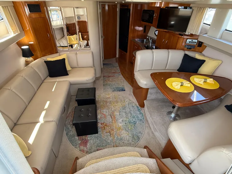 Slide: The Image of Luxurious interior of a 2006 Carver 36 Mariner yacht with elegant seating and dining area. - 24