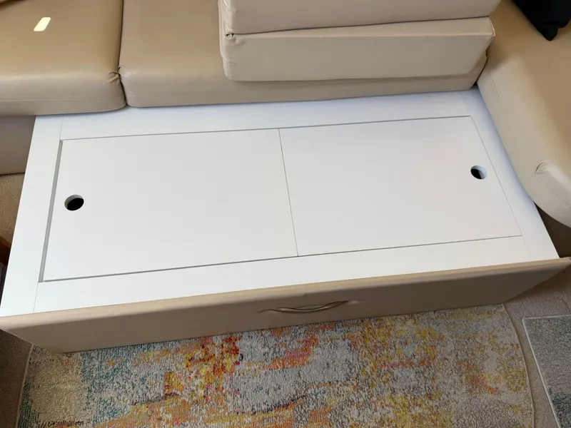 Slide: The Image of Interior of 2006 Carver 36 Mariner with beige seating and white storage compartment. - 28