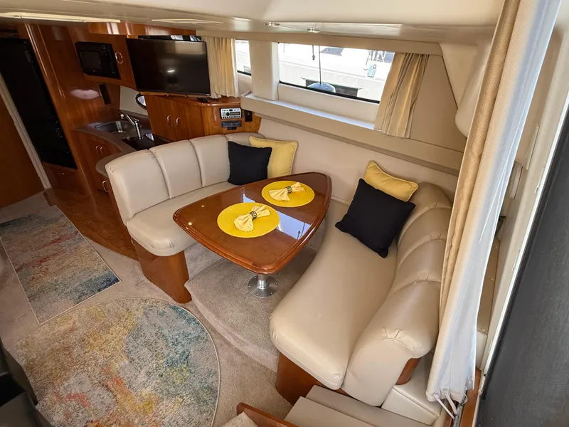 Slide: The Image of Interior of 2006 Carver 36 Mariner yacht with cozy dining area and modern amenities. - 30