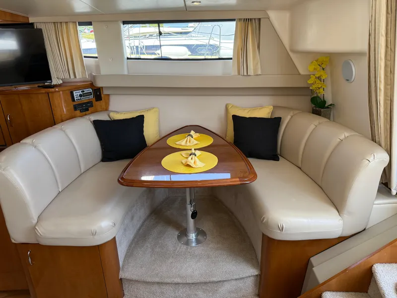 Slide: The Image of Interior of 2006 Carver 36 Mariner yacht with cozy dining area and elegant decor. - 31