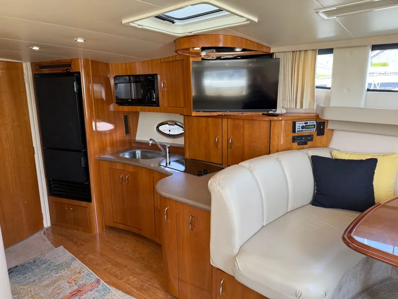 Slide: The Image of 2006 Carver 36 Mariner interior with kitchenette, TV, and seating area. - 32