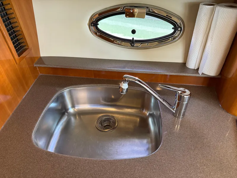 Slide: The Image of Stainless steel sink in 2006 Carver 36 Mariner yacht kitchen with porthole and paper towels. - 37