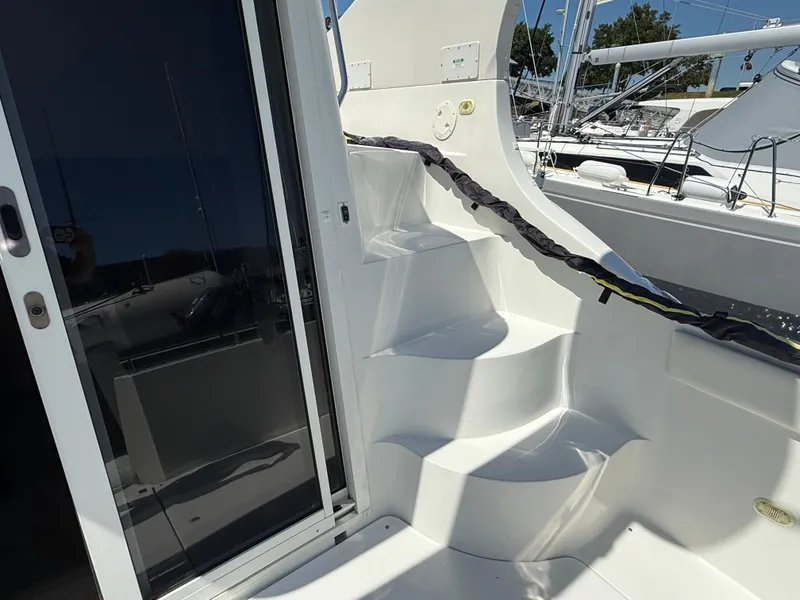 Slide: The Image of Staircase on 2006 Carver 36 Mariner yacht, featuring sleek white design and glass door. - 4