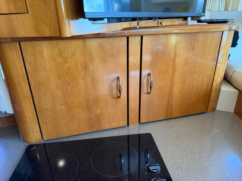 Slide: The Image of Wooden cabinetry and stovetop in 2006 Carver 36 Mariner yacht interior. - 41