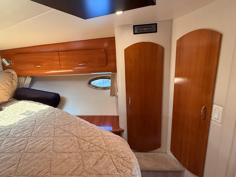 Slide: The Image of Interior of 2006 Carver 36 Mariner yacht with wood cabinets and cozy bedding. - 46