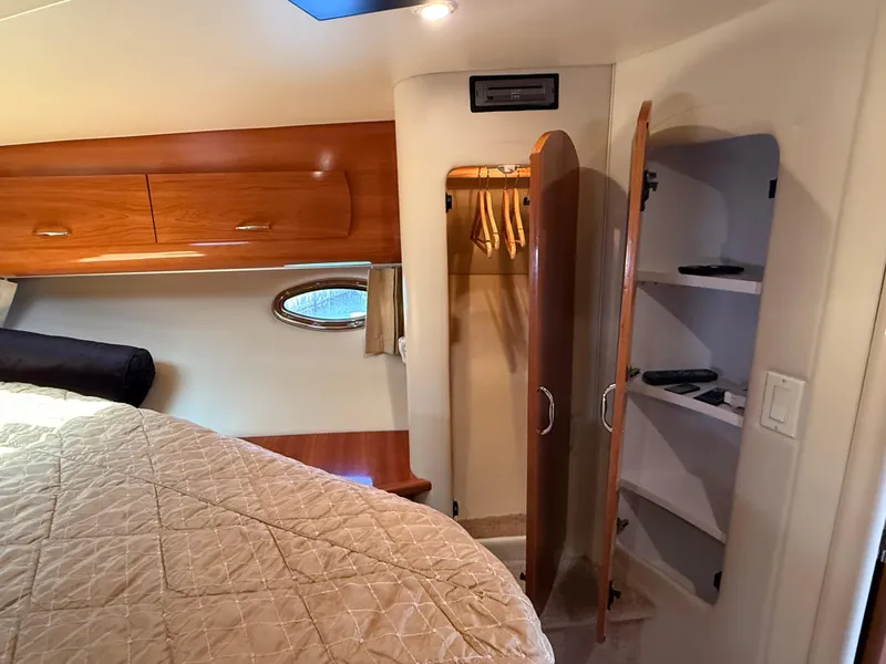 Slide: The Image of Interior of 2006 Carver 36 Mariner with bed, closet, and shelves. - 47