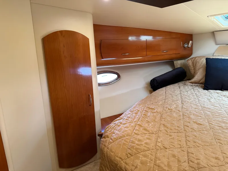 Slide: The Image of Luxurious cabin interior of 2006 Carver 36 Mariner with wood accents and cozy bedding. - 48