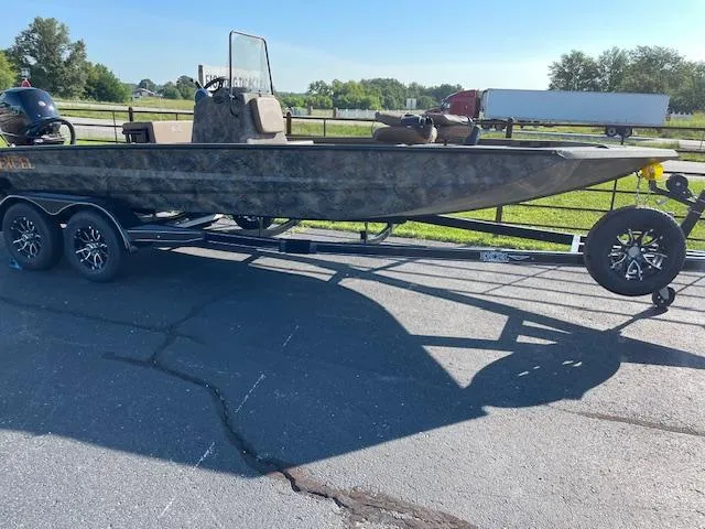 The Image of 2025 Excel 2172 Cat Pro CC boat on trailer, parked on asphalt. - 1