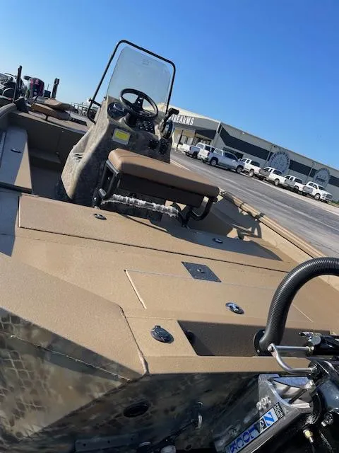 Slide: The Image of 2025 Excel 2172 Cat Pro CC boat with console and seating, parked outdoors. - 4