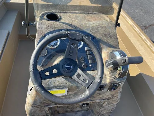 Slide: The Image of Steering console of 2025 Excel 2172 Cat Pro CC boat with camouflage design. - 5
