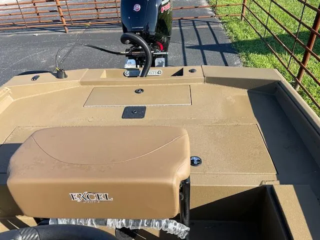 Slide: The Image of 2025 Excel 2172 Cat Pro CC boat with motor, tan interior, and outdoor setting. - 11