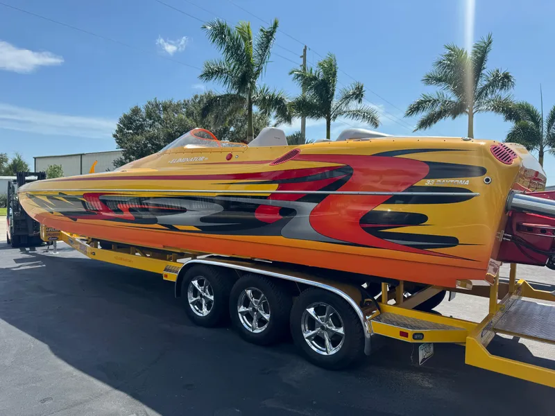 Slide: The Image of 2006 Eliminator 33 Daytona speedboat with vibrant custom paint, parked on a trailer. - 13