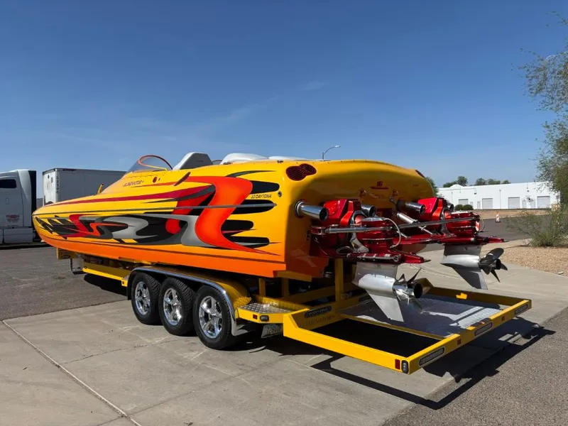 Slide: The Image of 2006 Eliminator 33 Daytona speedboat with vibrant graphics on a trailer. - 15