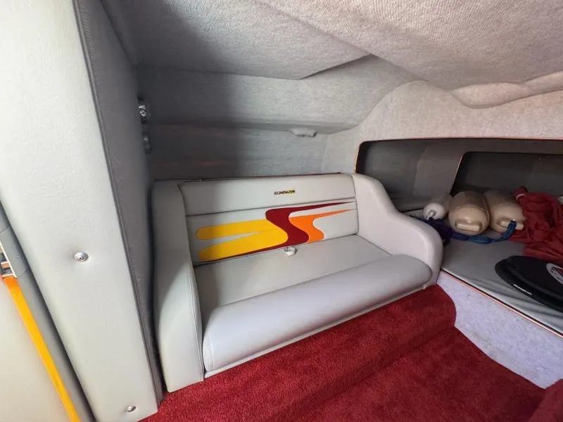 Slide: The Image of Interior of a 2006 Eliminator 33 Daytona boat with red and gray seating. - 21