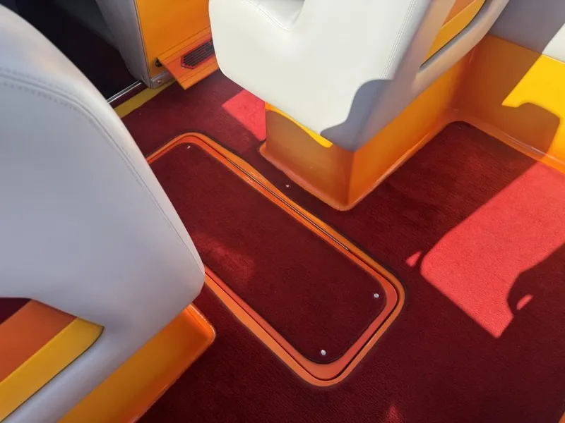 Slide: The Image of 2006 Eliminator 33 Daytona interior with red carpet and orange accents. - 24