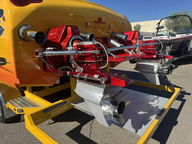 Slide: The Image of 2006 Eliminator 33 Daytona boat with dual red engines and polished propellers. - 30