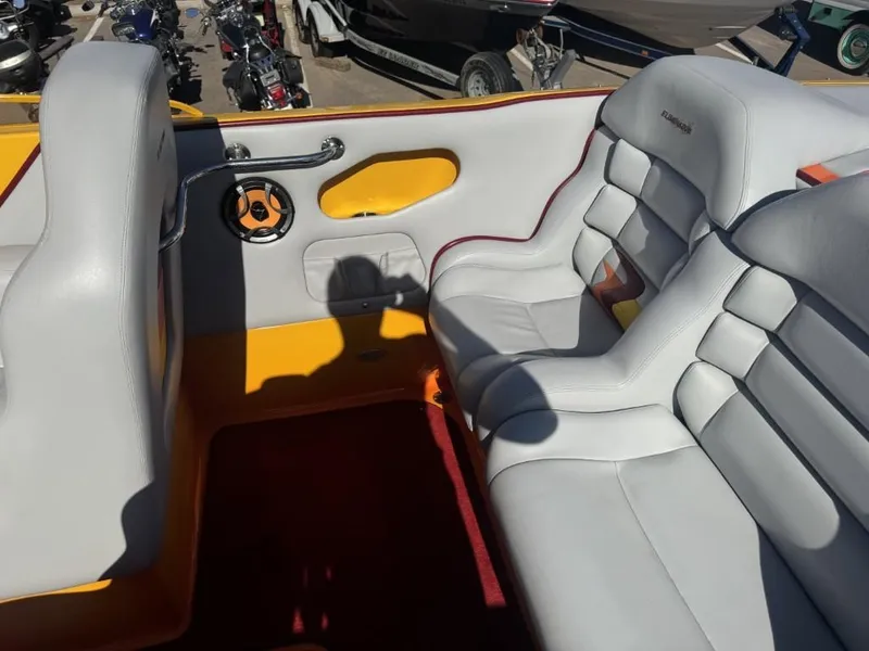 Slide: The Image of 2006 Eliminator 33 Daytona boat interior with white leather seats and yellow accents. - 37