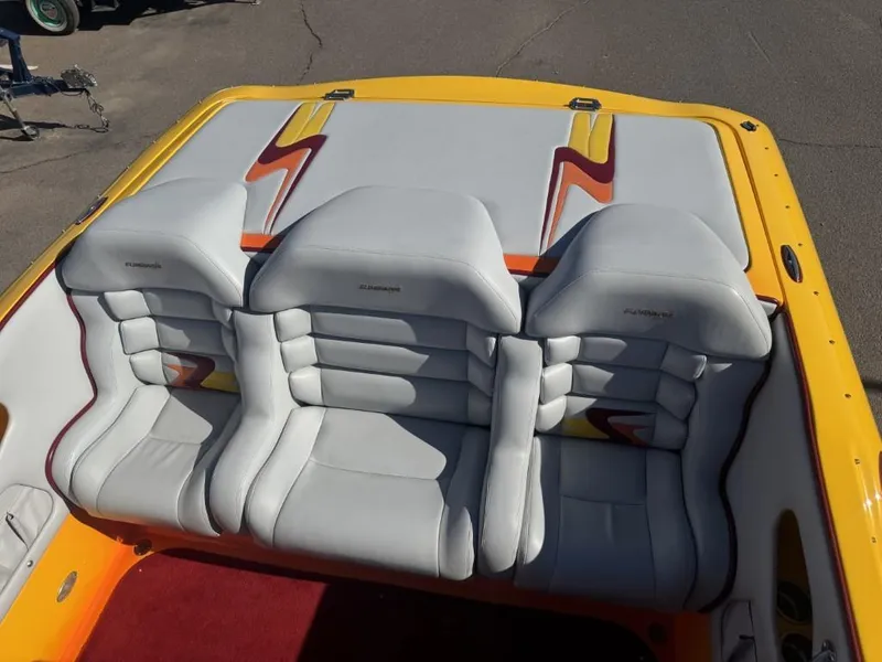Slide: The Image of 2006 Eliminator 33 Daytona boat interior with white and yellow seats, red carpet. - 39