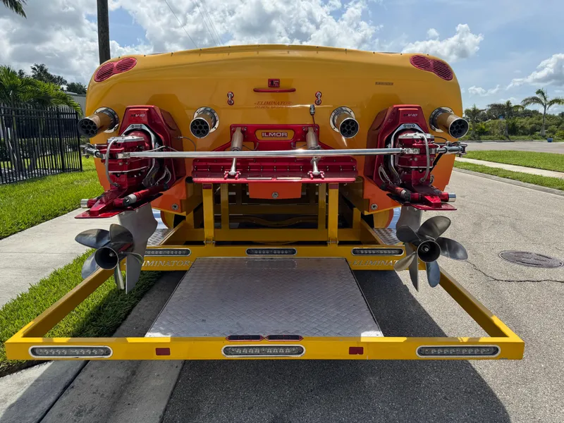 Slide: The Image of 2006 Eliminator 33 Daytona boat on trailer, showcasing dual propellers and vibrant yellow design. - 4