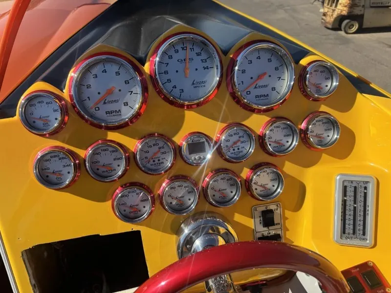 Slide: The Image of Dashboard of a 2006 Eliminator 33 Daytona boat with multiple gauges and controls. - 41