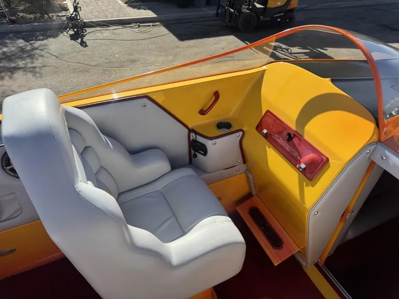 Slide: The Image of 2006 Eliminator 33 Daytona boat interior with white seating and vibrant yellow accents. - 42