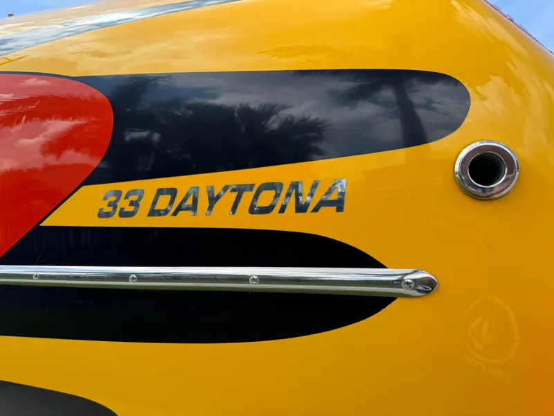 Slide: The Image of 2006 Eliminator 33 Daytona boat with vibrant yellow and black design. - 6