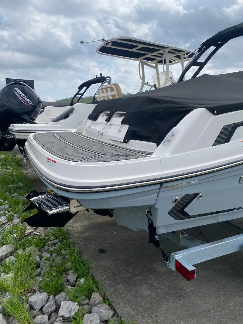 Slide: The Image of 2025 Bayliner VR5 Bowrider I/O boat with covered deck, parked on a trailer. - 3