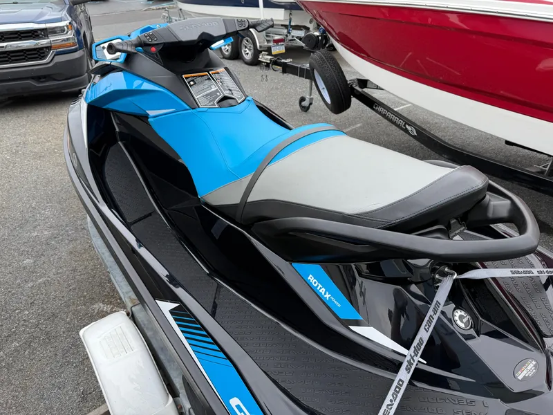 Slide: The Image of 2019 Sea-Doo GTR 230 jet ski in blue and black, parked on a trailer. - 5
