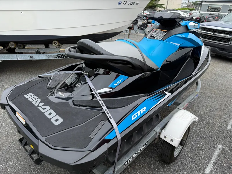 Slide: The Image of 2019 Sea-Doo GTR 230 jet ski on trailer, blue and black design. - 7