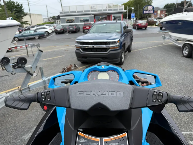 Slide: The Image of 2019 Sea-Doo GTR 230 dashboard view in a parking lot with cars and boats. - 8