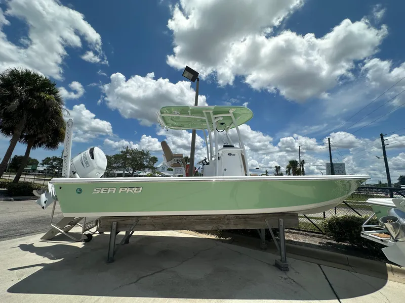 The Image of 2026 Sea Pro 250 Bay boat displayed outdoors under a partly cloudy sky. - 1