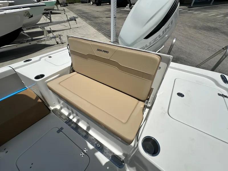 Slide: The Image of 2026 Sea Pro 250 Bay boat with beige seating and Suzuki engine. - 12