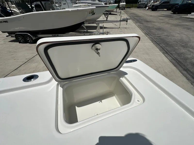 Slide: The Image of Open storage compartment on 2026 Sea Pro 250 Bay boat, docked outdoors. - 14