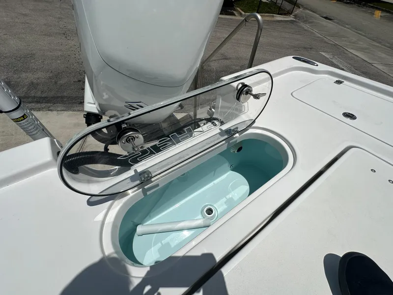 Slide: The Image of 2026 Sea Pro 250 Bay boat with open livewell and motor in view. - 15