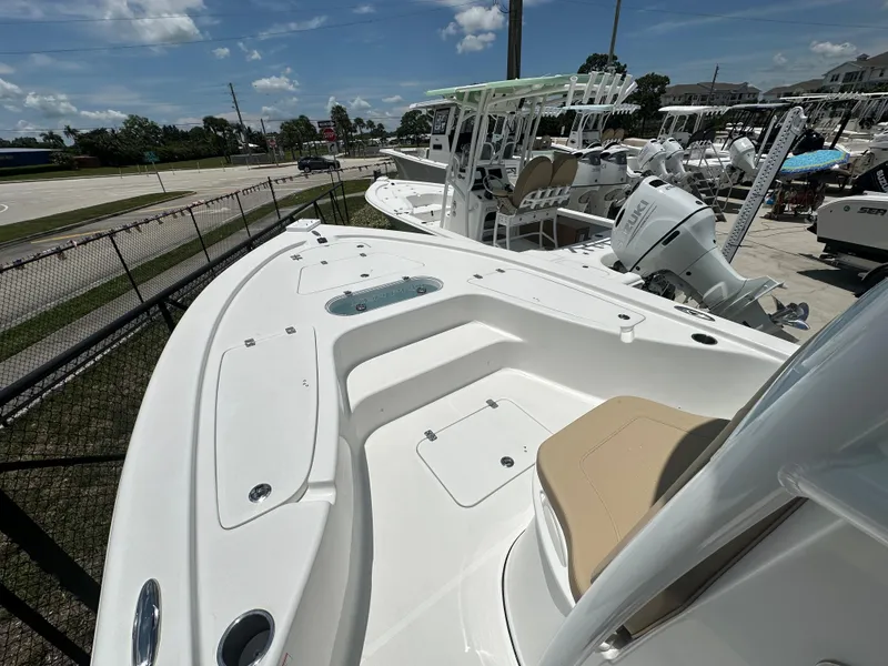 Slide: The Image of 2026 Sea Pro 250 Bay boat with spacious deck and seating, displayed outdoors. - 5