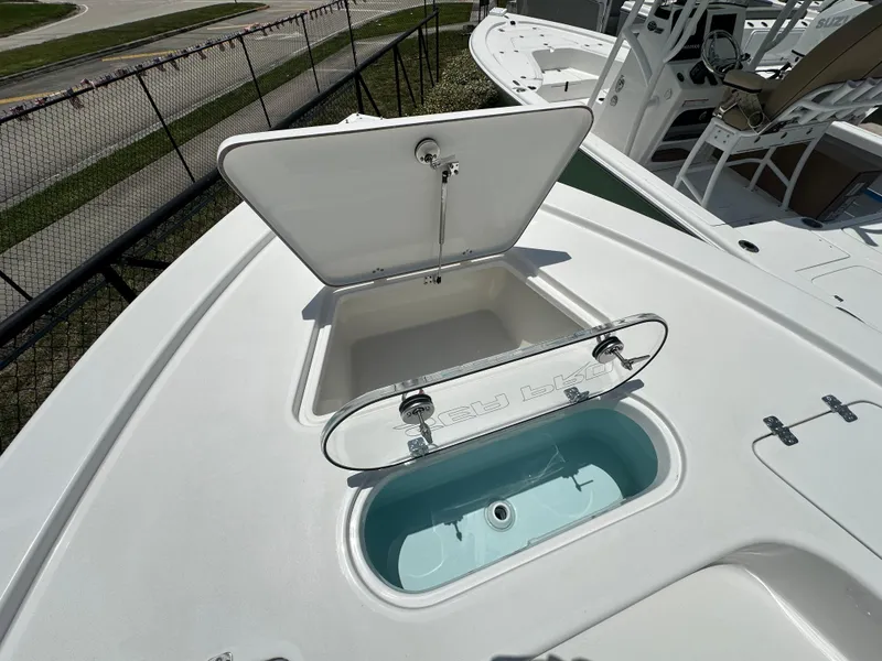 Slide: The Image of 2026 Sea Pro 250 Bay boat with open storage compartments on deck. - 7