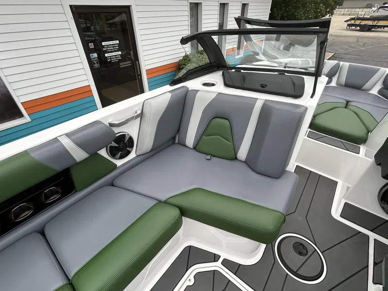 Slide: The Image of 2021 Malibu Wakesetter 21 VLX interior with green and gray seating, modern design. - 12