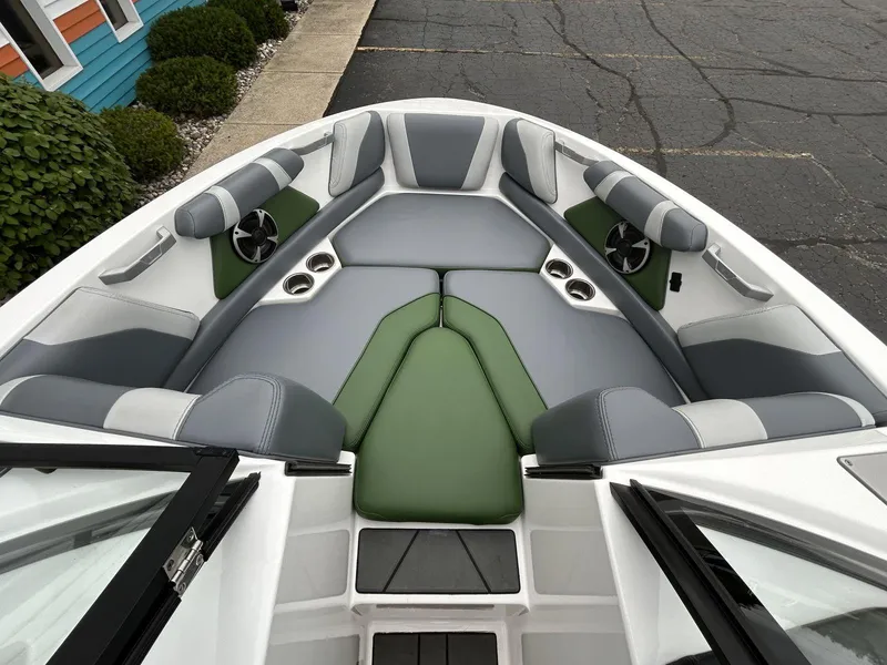 Slide: The Image of Interior of 2021 Malibu Wakesetter 21 VLX boat with green and gray seating. - 13