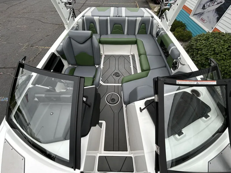 Slide: The Image of 2021 Malibu Wakesetter 21 VLX interior with green and gray seating, open windshield view. - 14