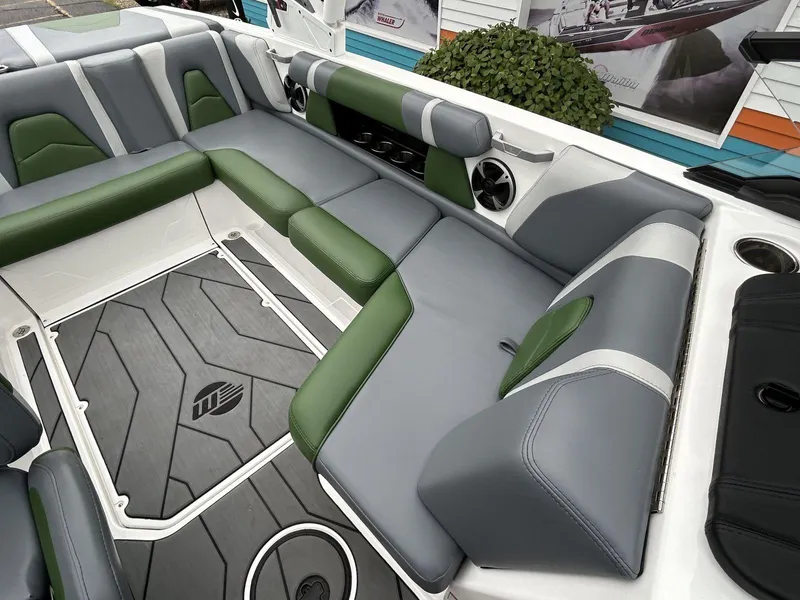 Slide: The Image of 2021 Malibu Wakesetter 21 VLX interior with gray and green seating, modern design. - 16