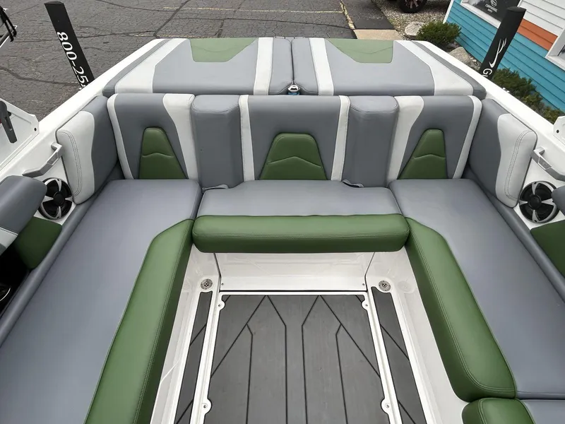 Slide: The Image of 2021 Malibu Wakesetter 21 VLX boat interior with green and gray seating. - 17