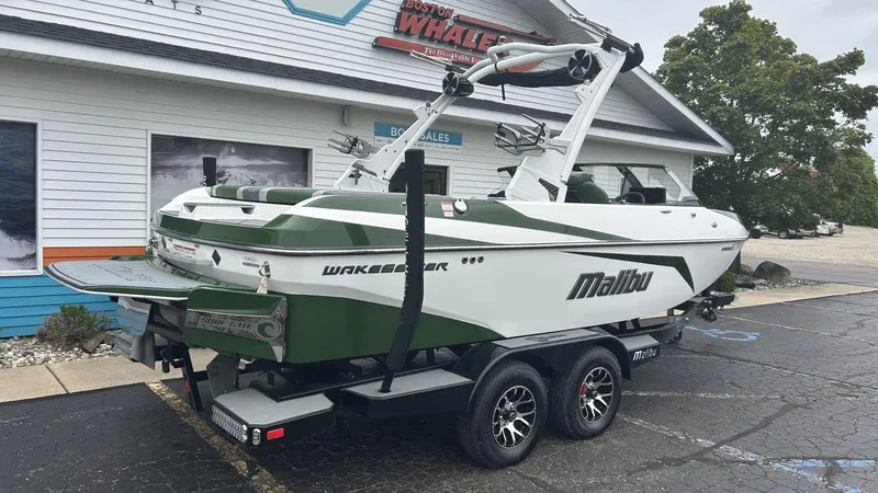 Slide: The Image of 2021 Malibu Wakesetter 21 VLX boat on trailer outside dealership. - 2