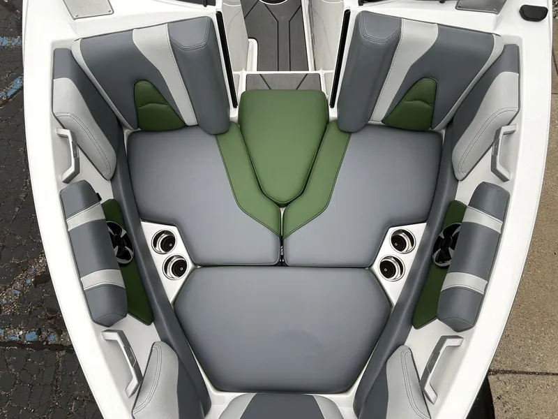 Slide: The Image of 2021 Malibu Wakesetter 21 VLX boat interior with gray and green cushioned seating. - 20