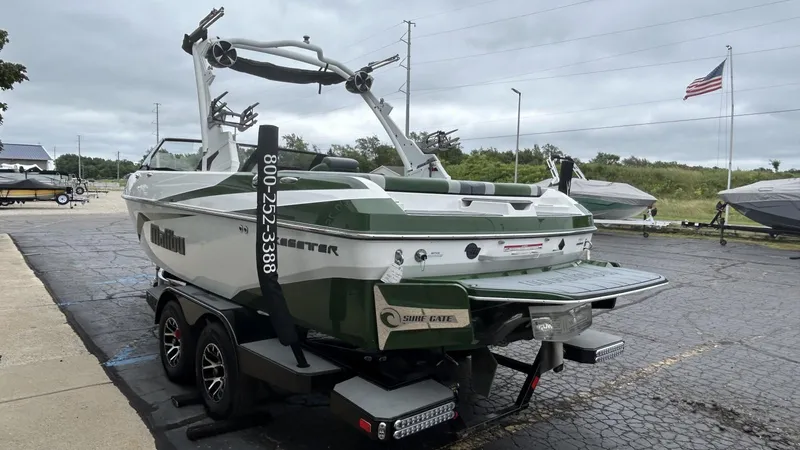 Slide: The Image of 2021 Malibu Wakesetter 21 VLX boat on trailer, parked outdoors. - 4